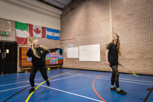 Girls smiling during a game of badminton doubles